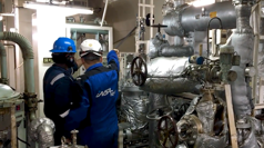 Two Insatech service technicians working in a machine room 