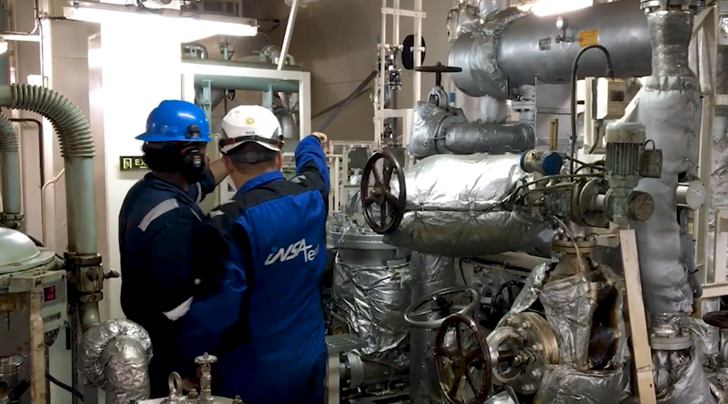Two Insatech service technicians working in a machine room 
